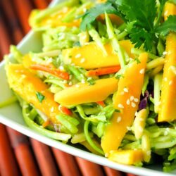 Fresh Mango Avocado Coleslaw topped with a garnish in a white bowl.