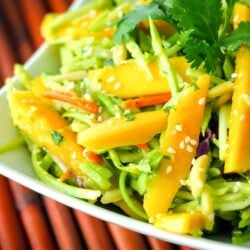 Fresh Mango Avocado Coleslaw topped with a garnish in a white bowl.