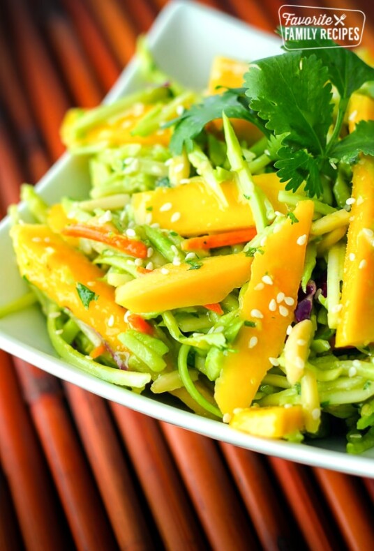 Fresh Mango Avocado Coleslaw topped with a garnish in a white bowl.