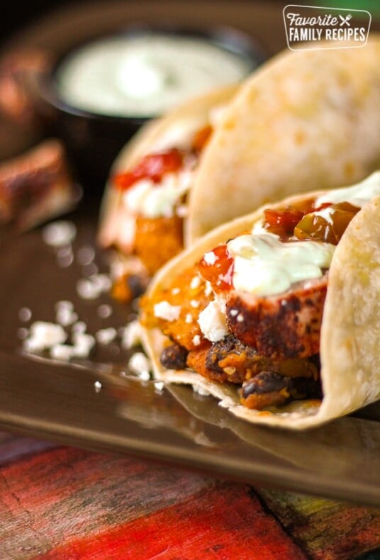 Gourmet Butternut Squash Burritos on a brown plate.