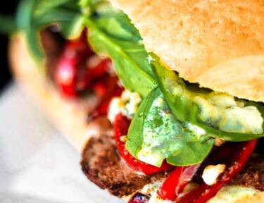 Close up of a Gourmet Steak Sandwich on a white plate.