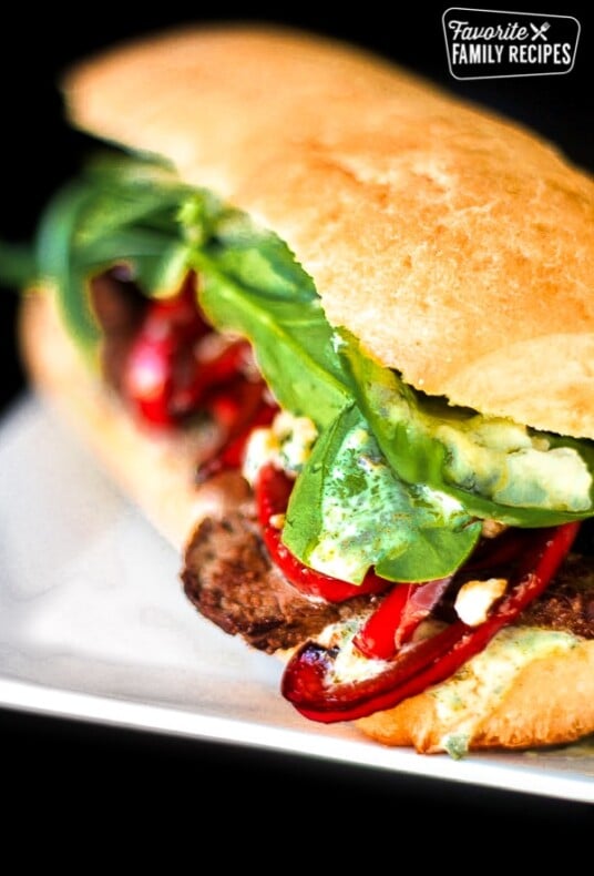 Close up of a Gourmet Steak Sandwich on a white plate.