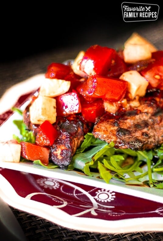 Close up of Grilled Balsamic Chicken with a chilled Bruschetta Topping on a plate.