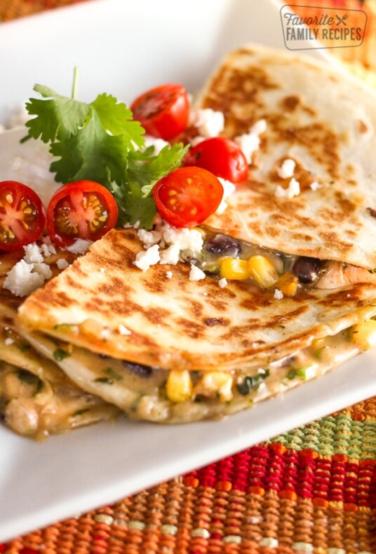 Low-Cal Veggie Quesadillas topped with tomatoes, cilantro, and feta cheese.
