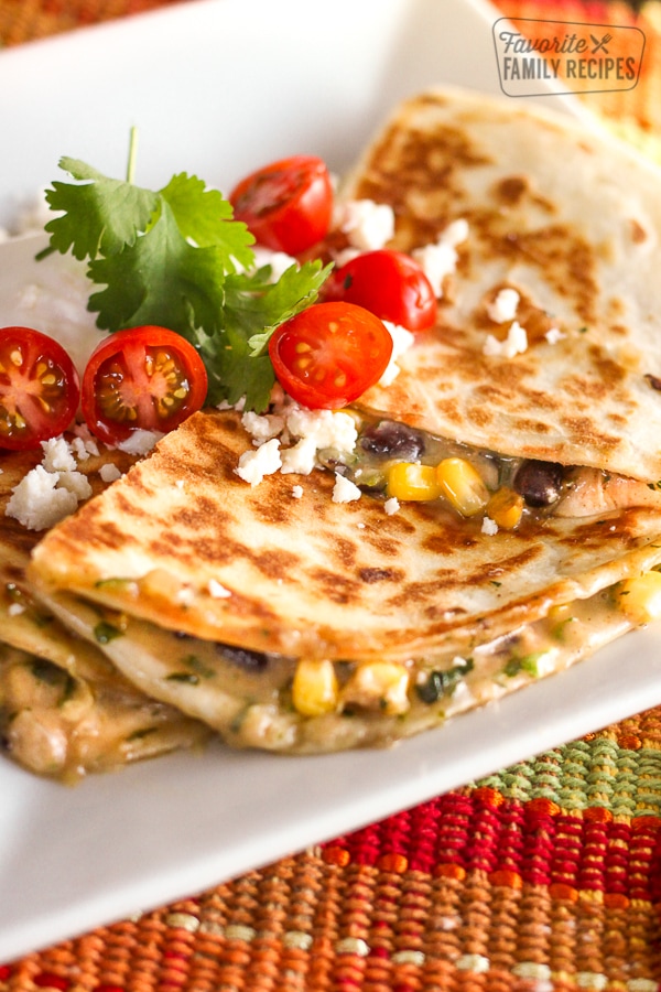 Low-Cal Veggie Quesadillas topped with tomatoes, cilantro, and feta cheese.