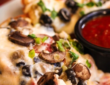 Loaded Cheesy French Bread with a side of marina sauce.