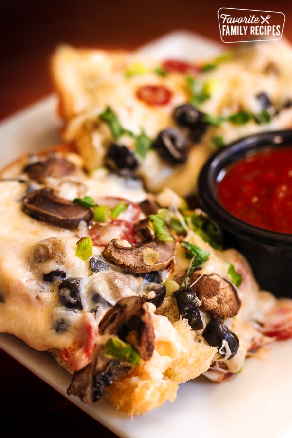 Loaded Cheesy French Bread with a side of marina sauce.