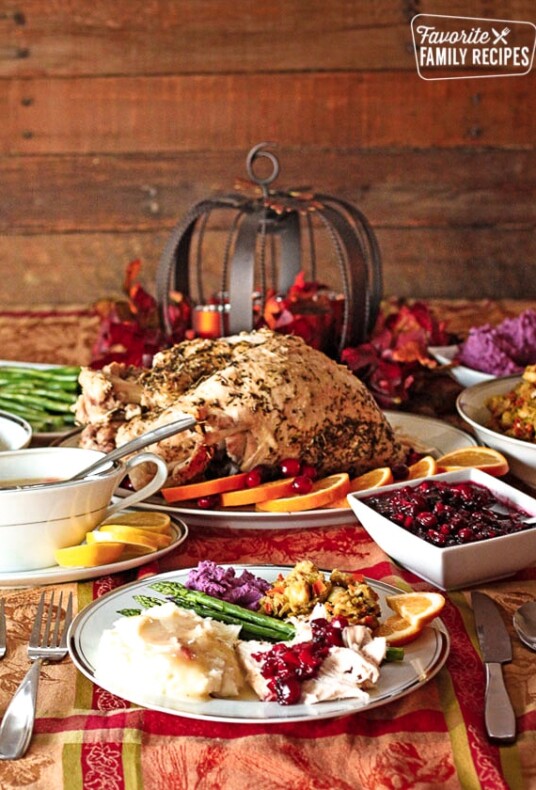 A low calorie Thanksgiving Dinner with turkey, gravy, cranberry sauce and stuffing on a decorated tablecloth