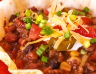 Mexican Chili topped with cheese and green onions in a Tostada Bowl