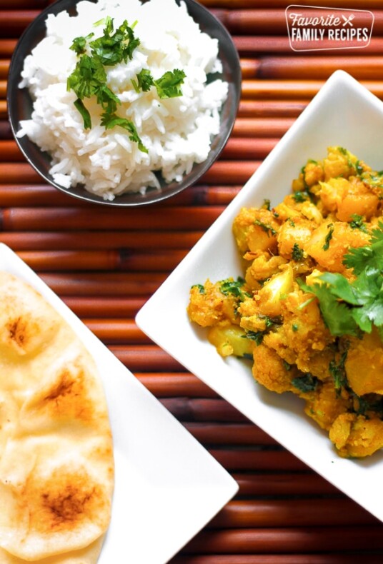 Curried Cauliflower and Potatoes in a Dish with Naan Bread on the side