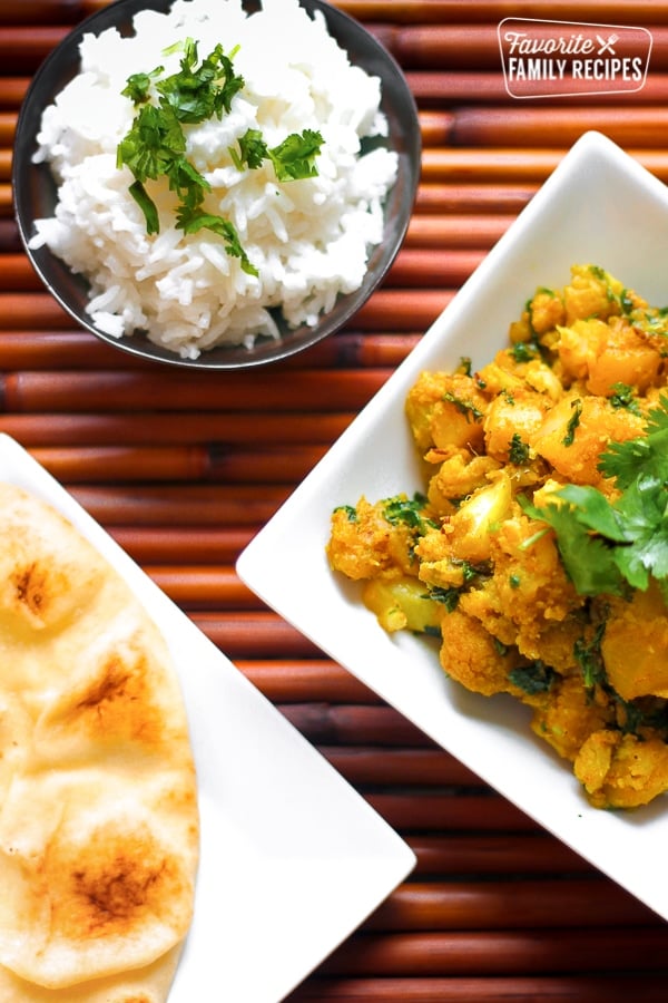 Curried Cauliflower and Potatoes in a Dish with Naan Bread on the side