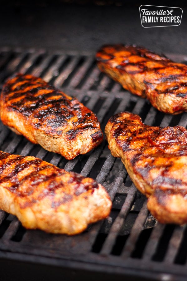 4 pieces of steak on the grill marinated with the New York Steak Rub.