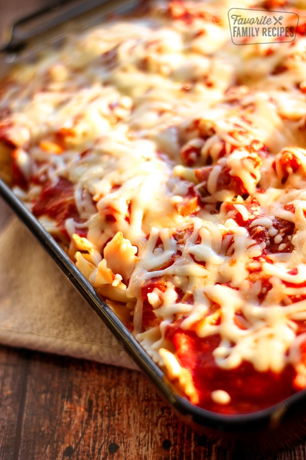 Pasta Sausage Bake topped with melted cheese in a glass pan