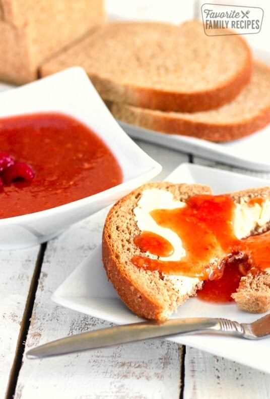 Raspberry peach freezer jam on a slice of toast.