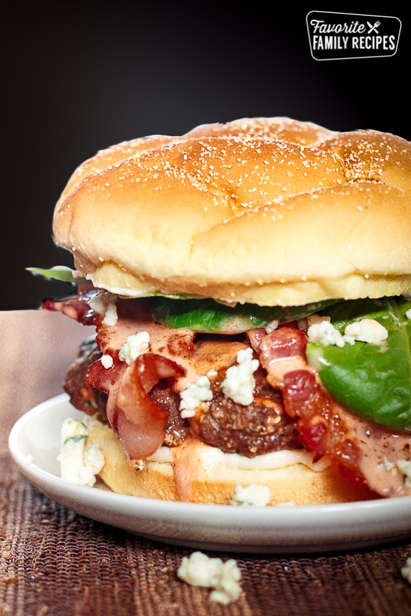 Bacon & Blue Cheese Burgers with Creamy Buffalo Sauce on a white plate.