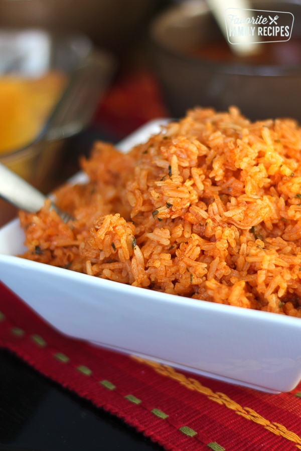A square white dish filled with restaurant style Mexican rice