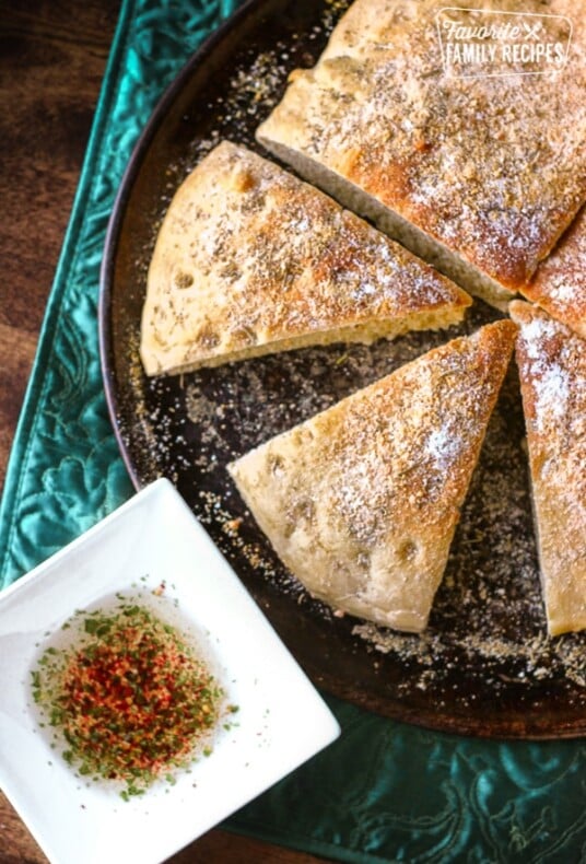 Rosemary parmesan focaccia bread cut into slices.