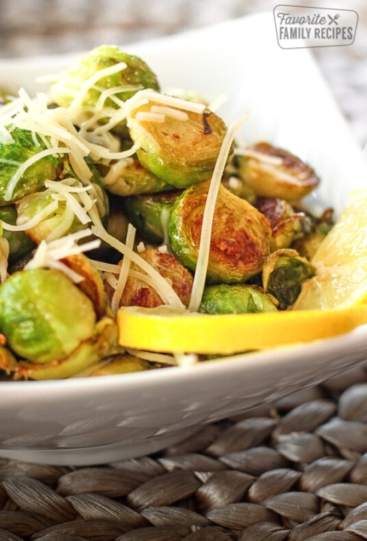Sauteed lemon garlic brussels sprouts in a white bowl.