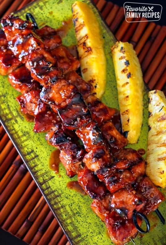 Pork Kabobs on a serving platter with pineapple