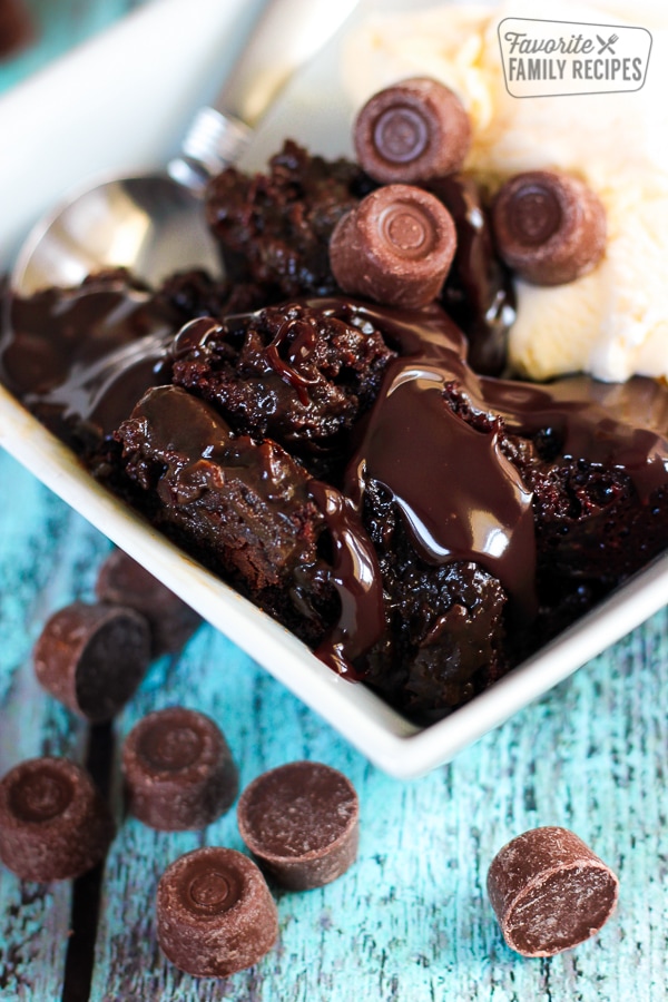 bowl of slow cooker molten chocolate cake with spoon and rolo garnish