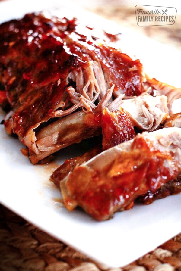 A plate of Sweet and Spicy Crock Pot Ribs with meat coming off the bone