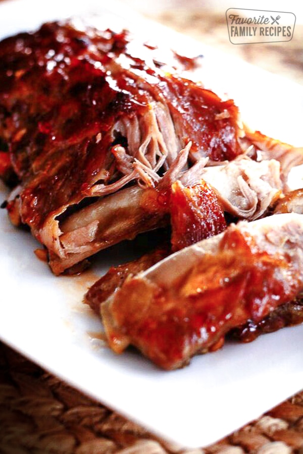 A plate of Sweet and Spicy Crock Pot Ribs with meat coming off the bone.