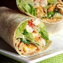 2 Chicken Caesar Wraps stacked on top of each other on a white plate.