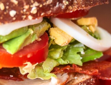 Close up of Cobb Salad Sandwich on a red plate.