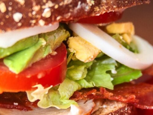 Close up of Cobb Salad Sandwich on a red plate.