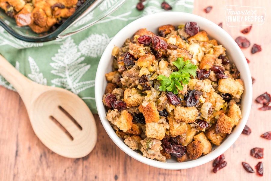 Cranberry sausage stuffing in a white bowl.