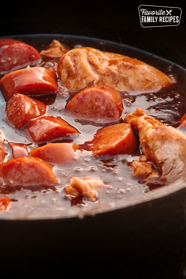 Dutch Oven Chicken and Sausage in a dutch oven.