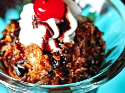 Fried Ice Cream topped with whipped cream and a cherry in a glass bowl.
