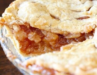 Apple pie with slice removed to show apple filling