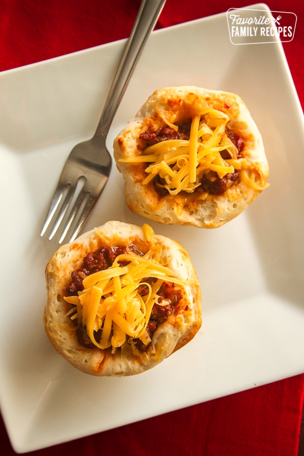 Sloppy joe biscuits on a white plate with a fork. 