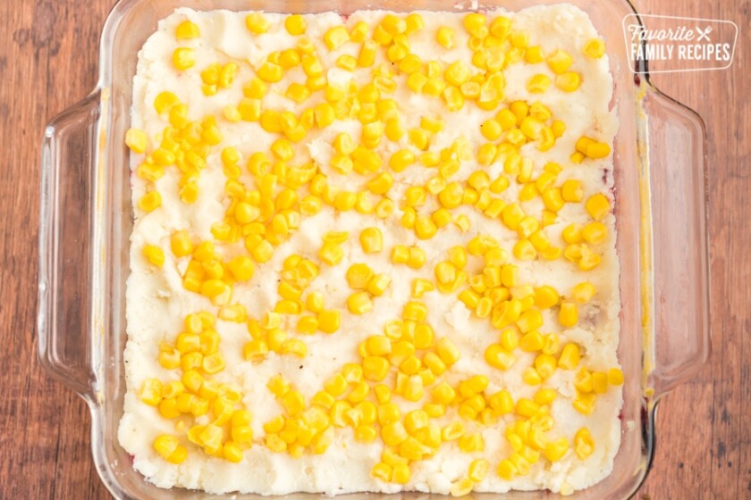 Mashed potatoes and corn spread out in a casserole dish