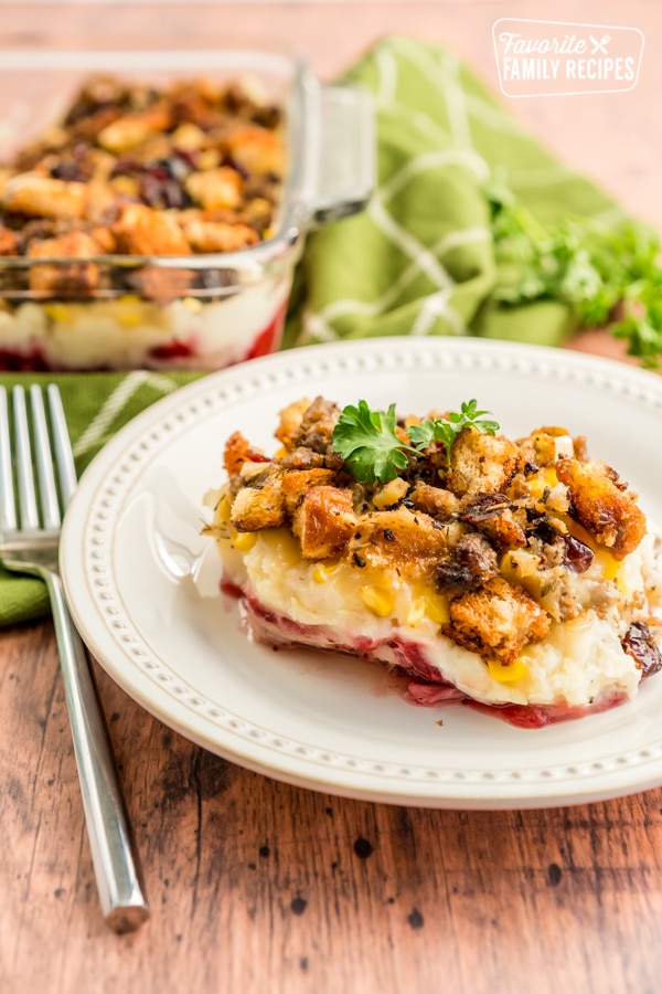 A scoop of Thanksgiving Leftover Casserole on a white plate with a fork next to it