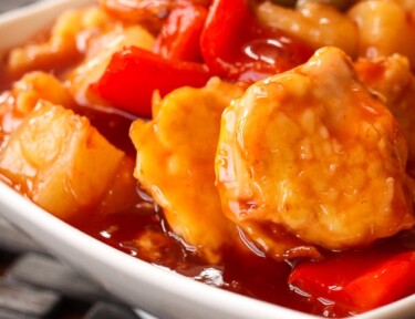 Baked Sweet and Sour Chicken in a white bowl.