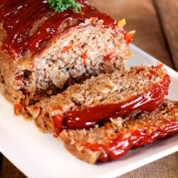 Claim Jumper Meatloaf with a couple slices on the end topped with a garnish.