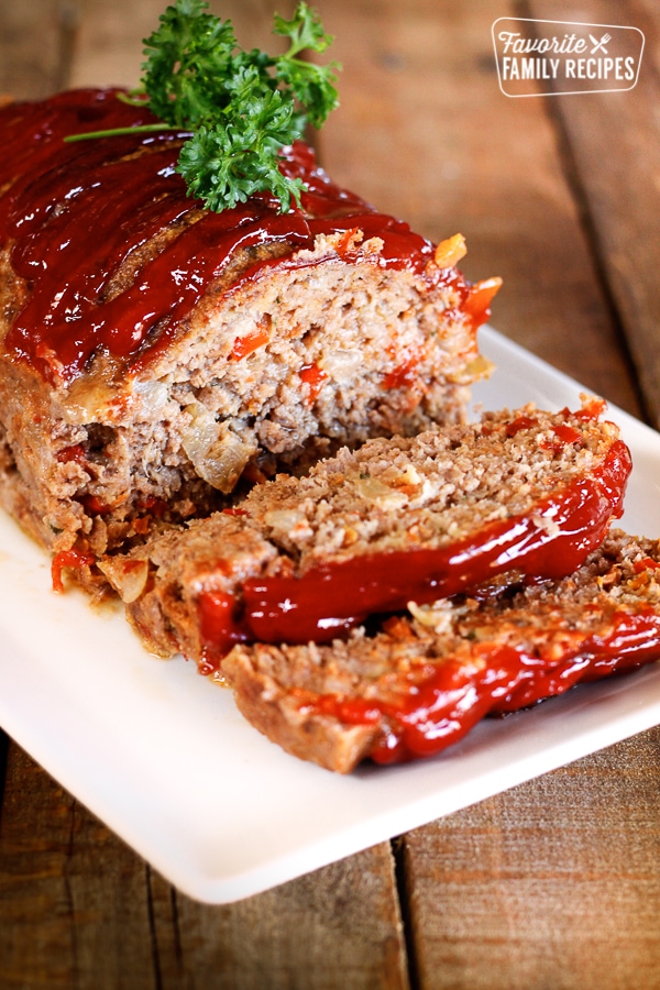 Claim Jumper Meatloaf with a couple slices on the end topped with a garnish.