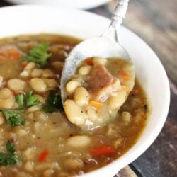 Close-up view of a spoonful of ham and bean soup