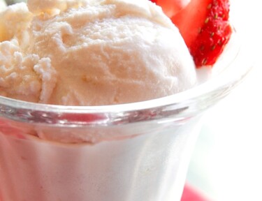Homemade Vanilla Ice Cream and strawberries in a glass.