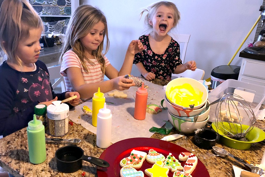 Cute girls decorating Christmas cookies.