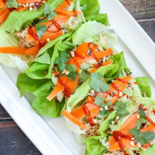 Lettuce wraps on a white serving platter.