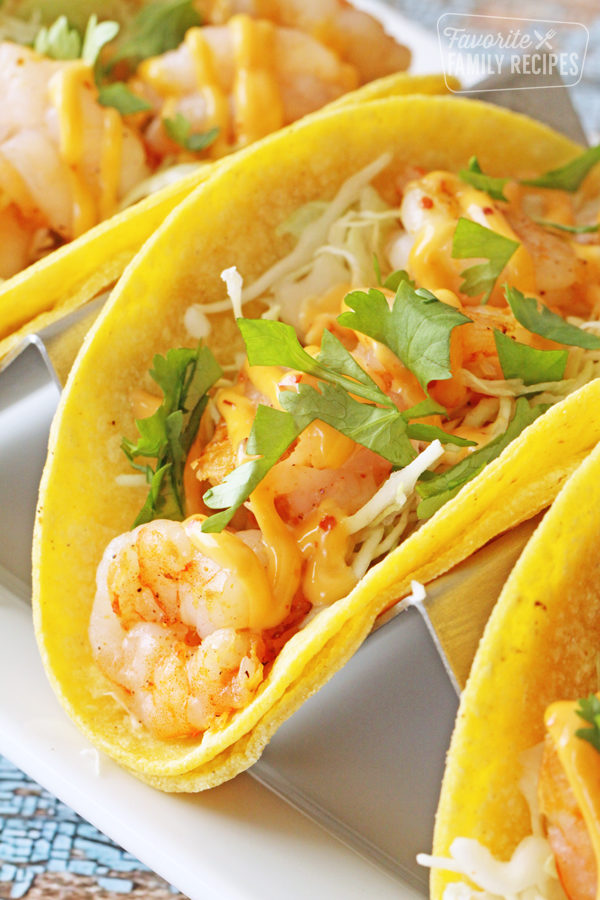 Three shrimp tacos on a plate