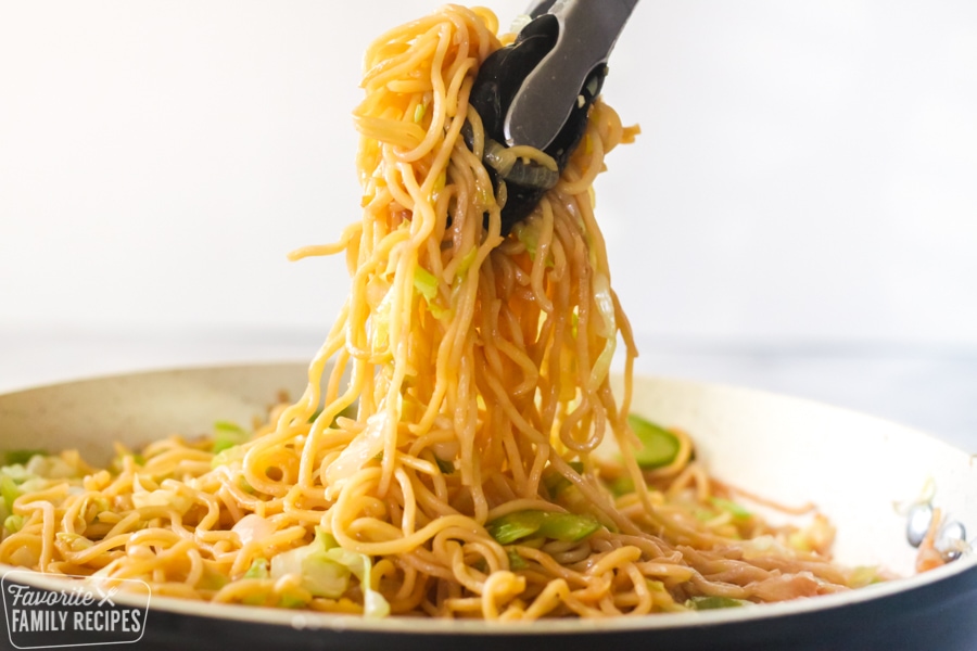 Chow mein noodles being served from a skillet