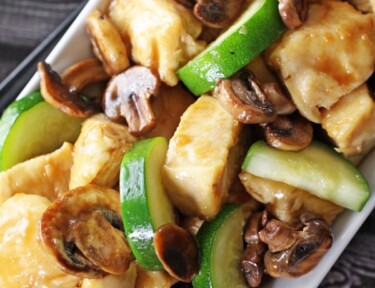 Panda Expres Mushroom Chicken on a plate with chicken, mushrooms, and zucchini