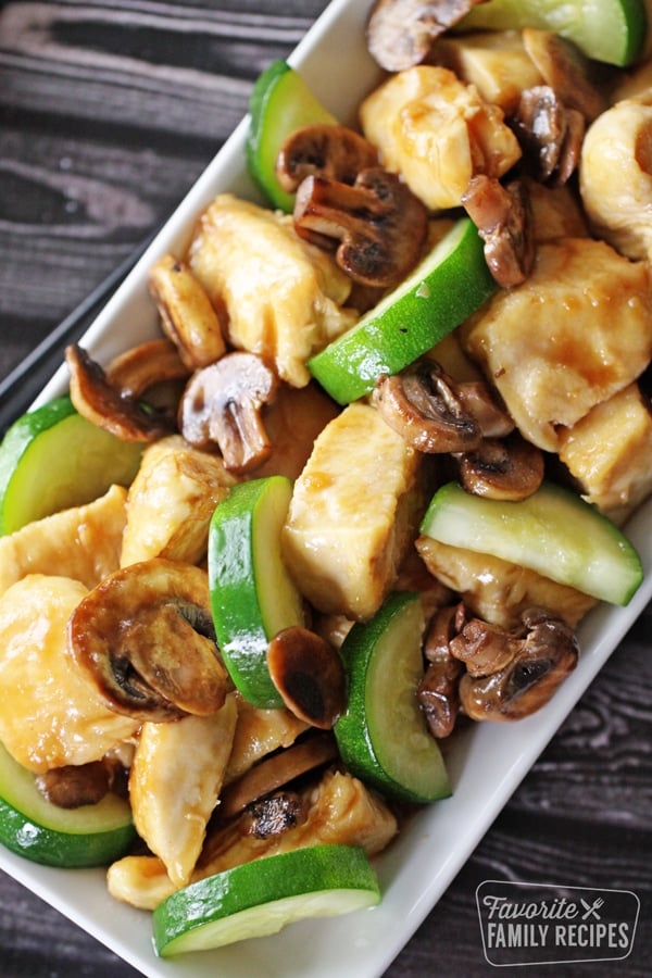 Panda Expres Mushroom Chicken on a plate with chicken, mushrooms, and zucchini