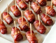 Bacon Wrapped Lil Smokies Appetizer with toothpicks in each one served on a white tray