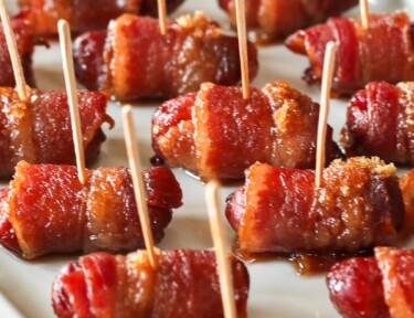 Bacon Wrapped Little Smokies Appetizers served on a white tray close-up view