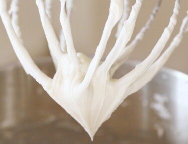 Cream cheese frosting on a whisk